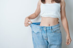 Slim woman in oversized jeans from weight loss with Semaglutide in Livermore, CA Slim woman in oversized jeans from weight loss with Semaglutide in Livermore, CA